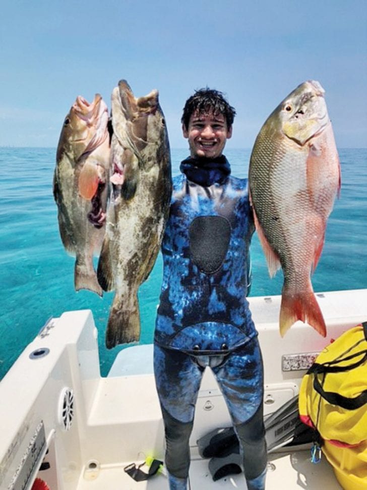 Mikey Rose with a pair of opening day grouper and a mutton snapper.