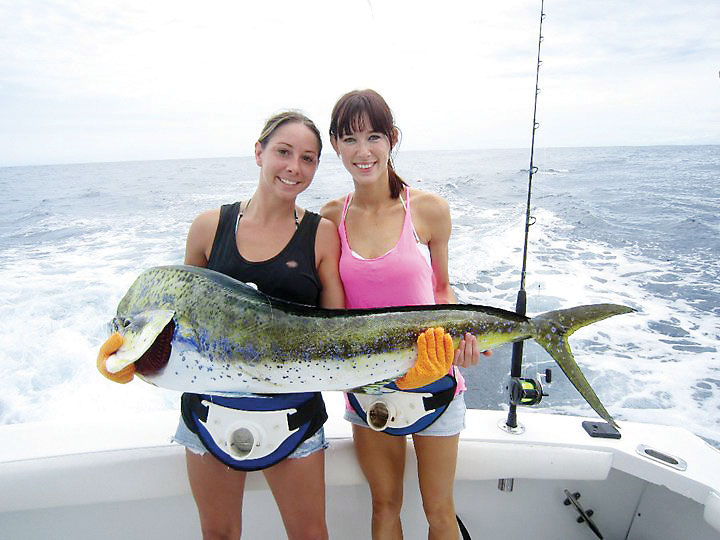 Ashley and Hope with a huge dolphin caught with New Lattitude Sportfishing.