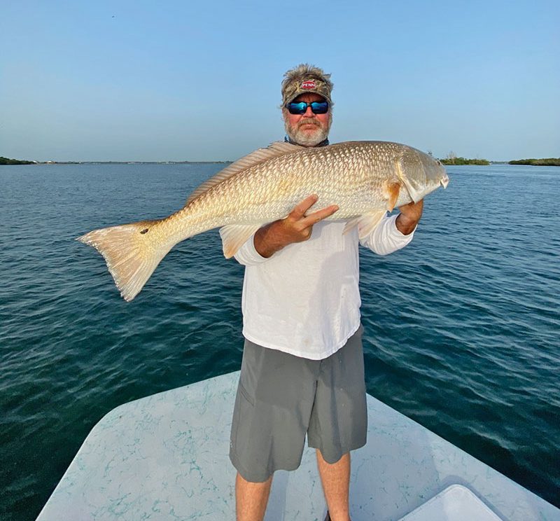 Mark with a hefty Inlet redfish.