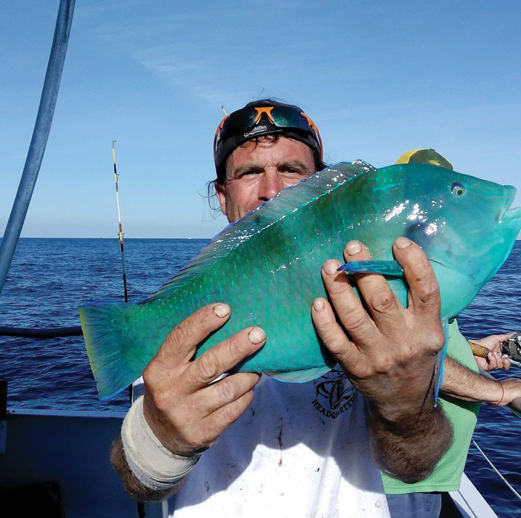 justin with a beautiful blue parrot fish coastal angler