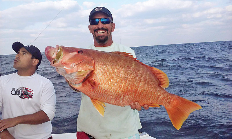 Mick with a huge snapper caught deep dropping on a charter with Fishing Headquarters.