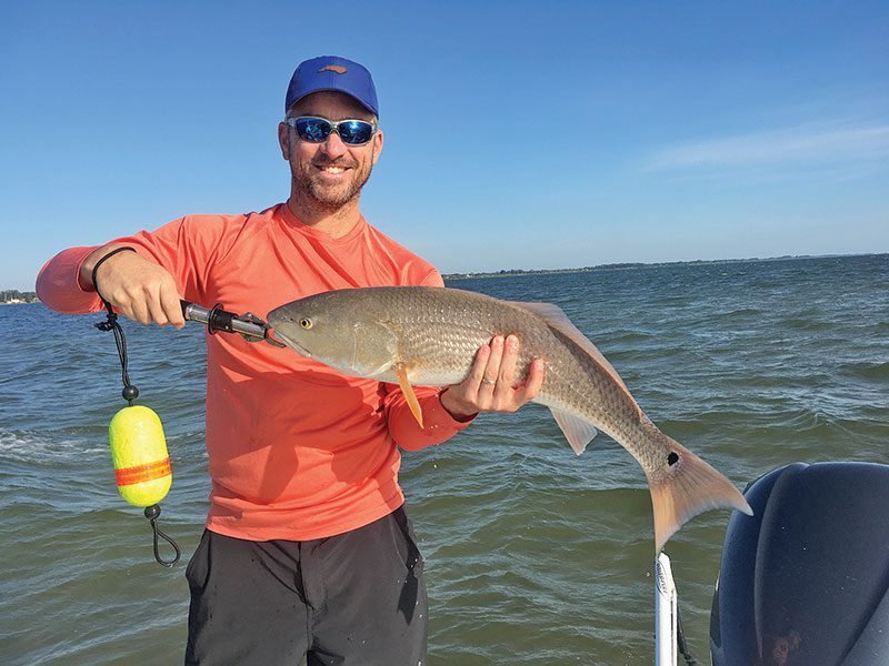 Rick Renfo with a slightly over-slot sized redfish caught on a live fingerling mullet.
