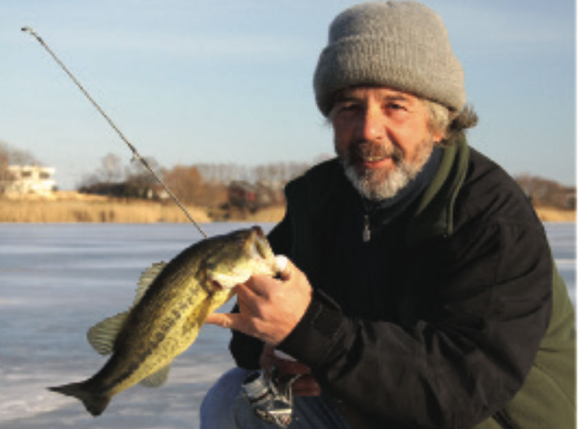 Marty Bazata caught and released this largemouth bass on a shallow Long Island Pond. It was his first catch through the ice. Photo by Tom Schlichter.