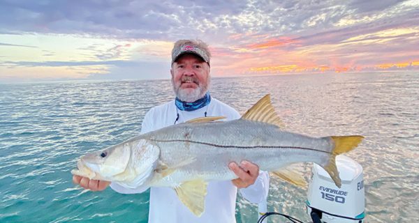 Mark with a nice beach snook in the mullet run.