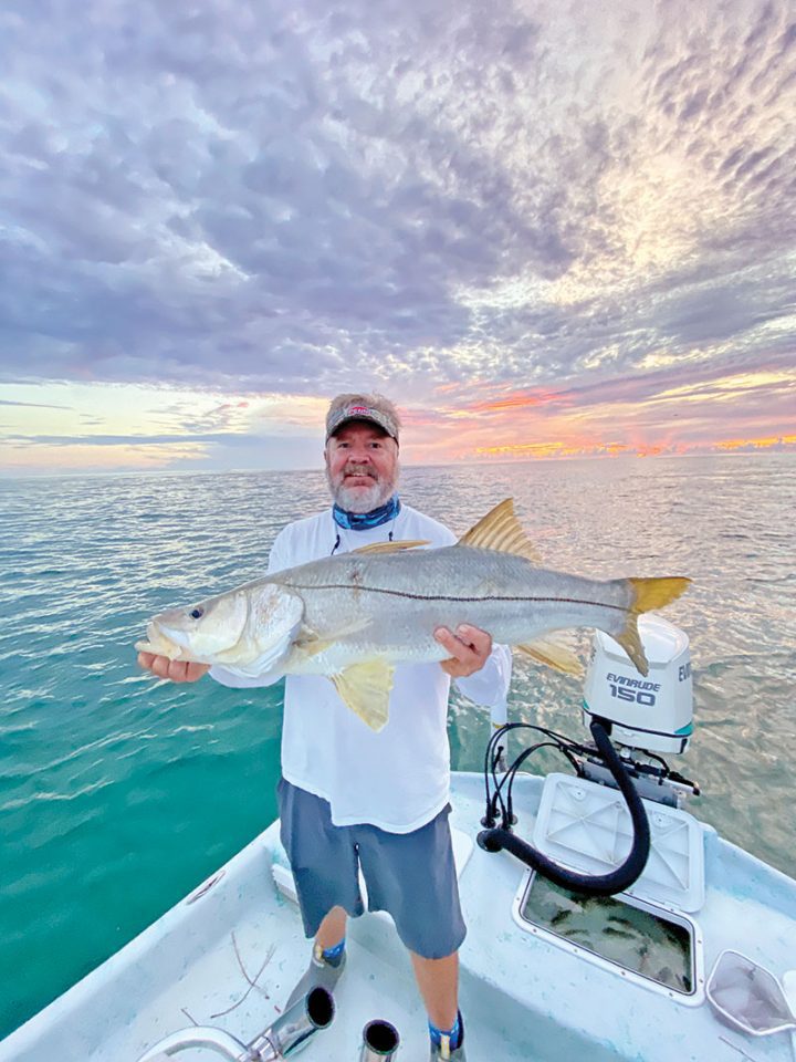 Mark with a nice beach snook in the mullet run.