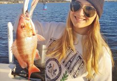 A lovely Ms. Dallas catching bay snapper on a chilly day with dad.