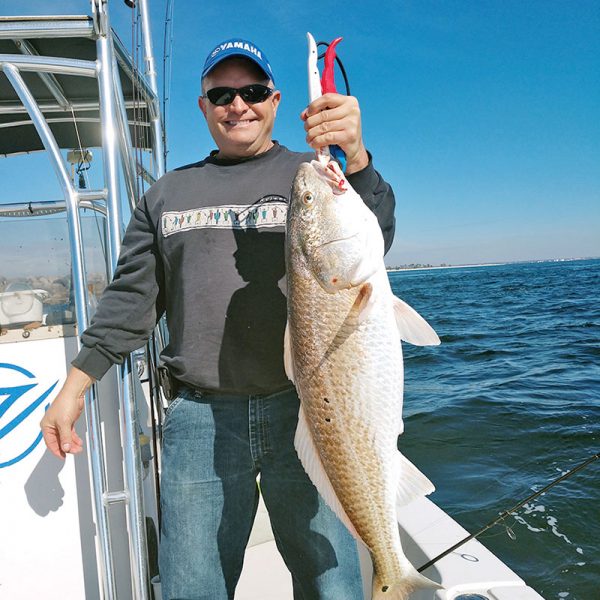 Aaron bagging bull reds on the C-note boat.