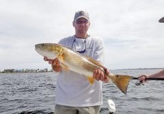 Andy Olson catching a few on a tough day with Capt. Jason.