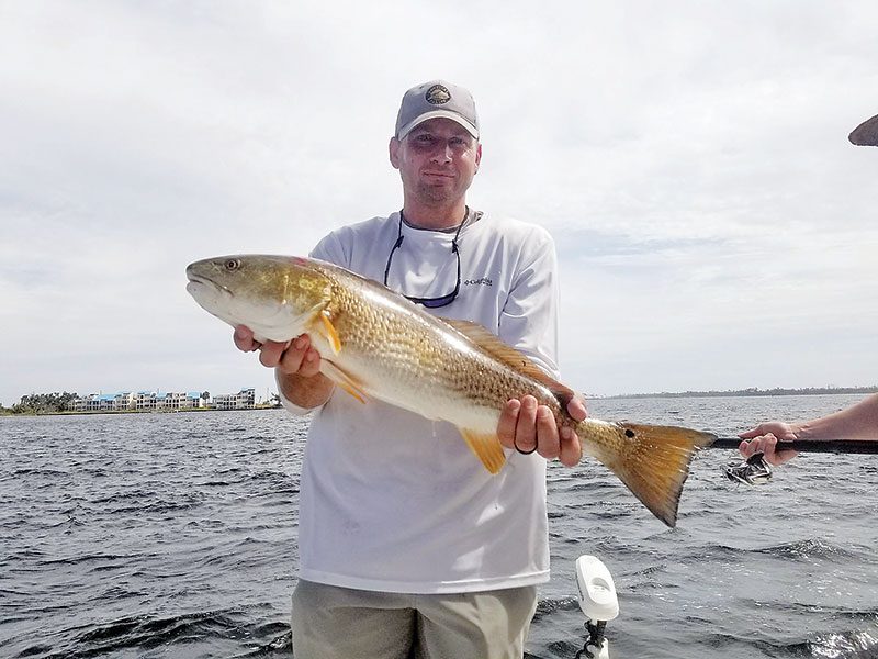 Andy Olson catching a few on a tough day with Capt. Jason.