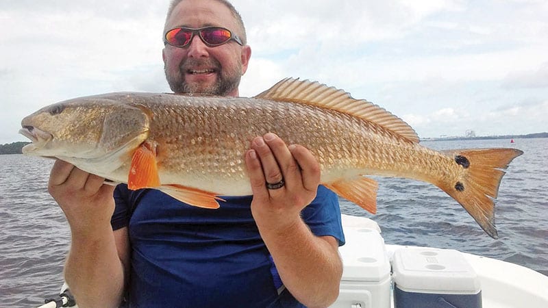 Butch Jobe with a nice redfish caught with Capt. Jason.
