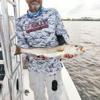 Capt C-note with one of the many big trout our bay system has been kicking out.