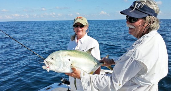 Capt. Chester holding a jack crevalle caught by Sherry Schmitt.