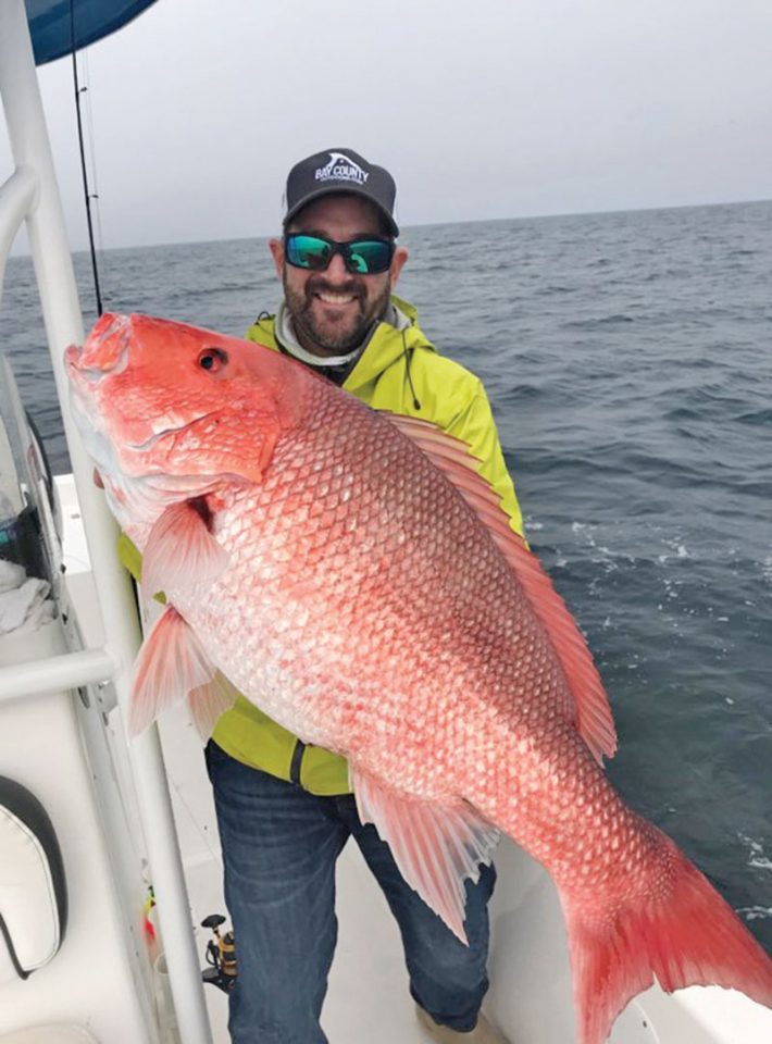 Capt. Phillip Wilds of Anchored Charters in PCB with a giant red snapper.