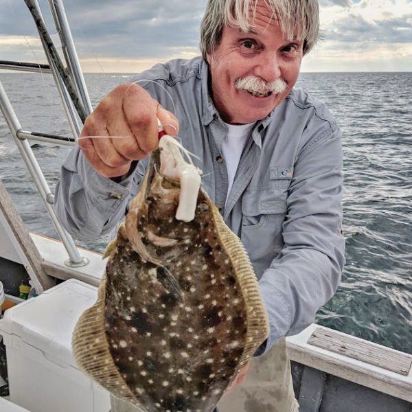 Capt. Chester Natural World Charters with an offshore flounder.