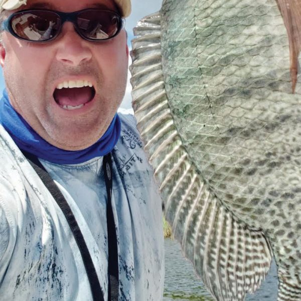 Chris Sabo is pumped over this Seminol tilapia...but look at the colors on this fish!