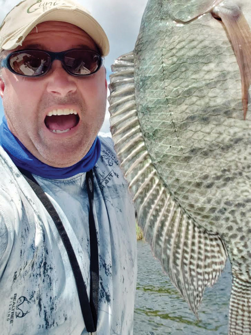 Chris Sabo is pumped over this Seminol tilapia...but look at the colors on this fish!