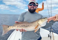 Daniel, here form Alabama, with a cool multi-spotted redfish he caught in St. Joe Bay fishing with Capt. Jordan Todd