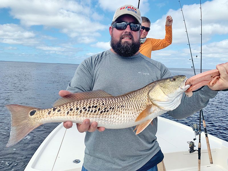 Daniel, here form Alabama, with a cool multi-spotted redfish he caught in St. Joe Bay fishing with Capt. Jordan Todd