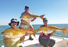 Demp, Traci and Frank from Leesburg, GA, tripled up on big bull reds off Cape San Blas.