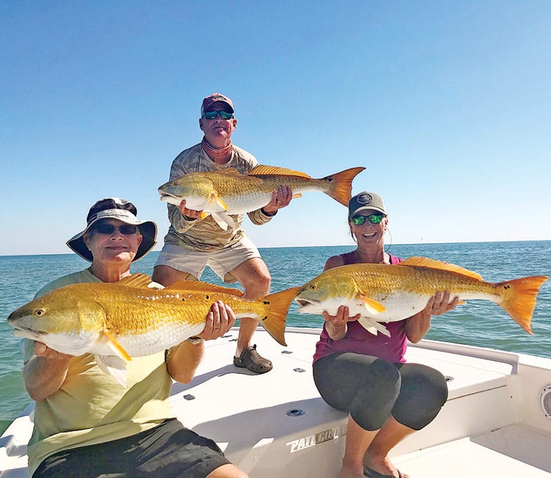 Demp, Traci and Frank from Leesburg, GA, tripled up on big bull reds off Cape San Blas.