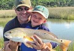 Henry Hatch, 5, with his first ever redfish while fishing with his dad and Capt. Jordan Todd.