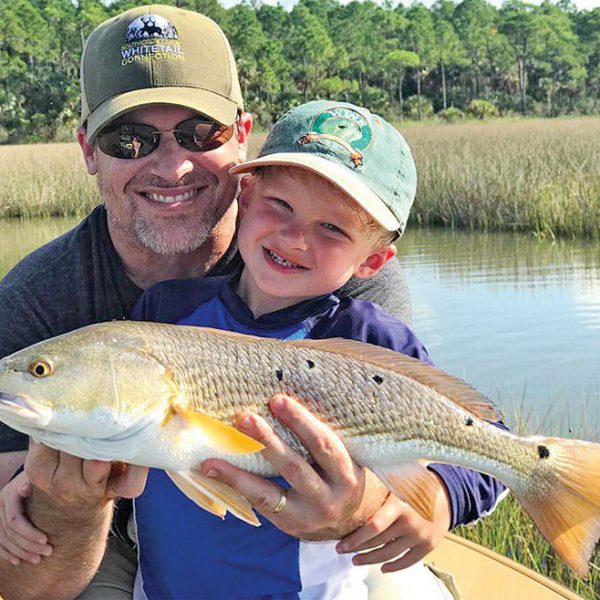 Henry Hatch, 5, with his first ever redfish while fishing with his dad and Capt. Jordan Todd.