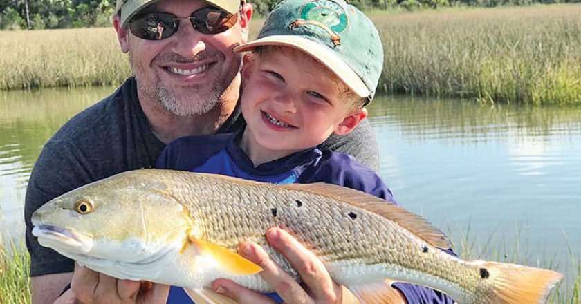 Henry Hatch, 5, with his first ever redfish while fishing with his dad and Capt. Jordan Todd.