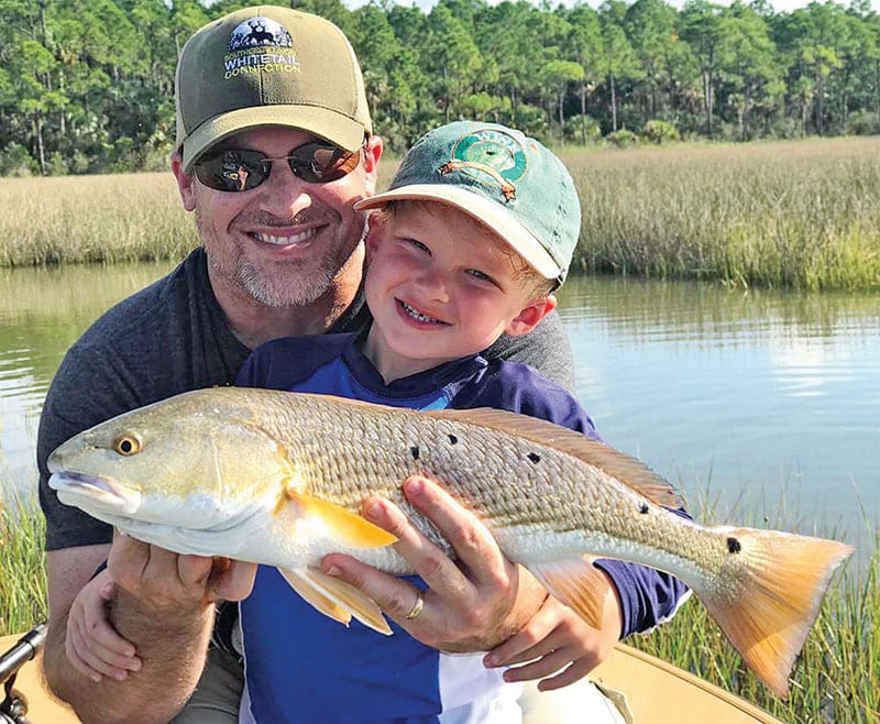 Henry Hatch, 5, with his first ever redfish while fishing with his dad and Capt. Jordan Todd.