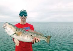 Jerrod Collins with an over slot redfish he caught in St. Joe bay on a Johnson gold spoon.