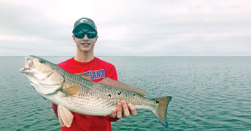 Jerrod Collins with an over slot redfish he caught in St. Joe bay on a Johnson gold spoon.