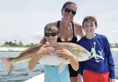 Jessy, Landon & Tanner with a monster red drum.