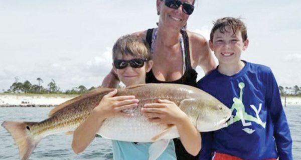 Jessy, Landon & Tanner with a monster red drum.