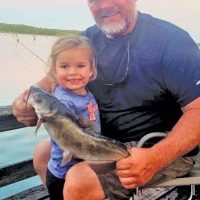 Ken Morey and his grandbaby, Autrey, with a nice cat she hauled in on Lake Seminole