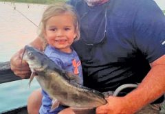 Ken Morey and his grandbaby, Autrey, with a nice cat she hauled in on Lake Seminole