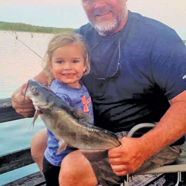 Ken Morey and his grandbaby, Autrey, with a nice cat she hauled in on Lake Seminole