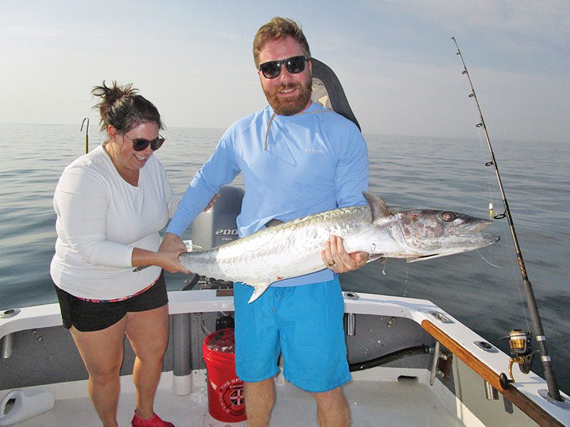 Kim and Bill Jones with a spring king aboard Natural World Charters with Capt. Chester Reese.