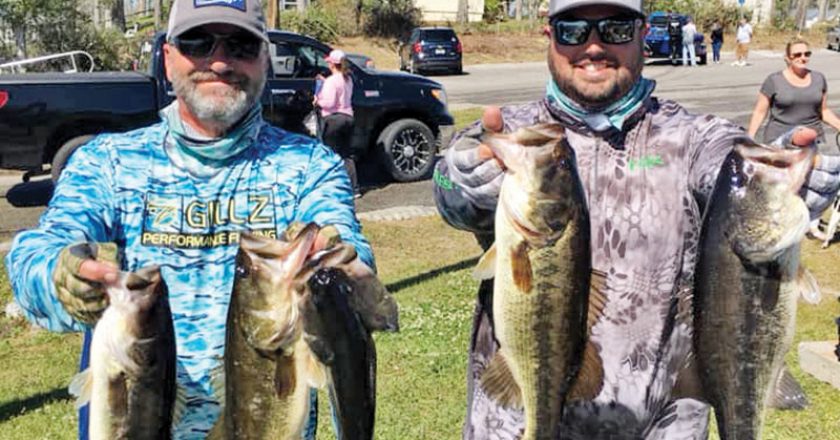 Kyle Pridgen and C-note with their winning 14 lb. bag of Deerpoint bass.