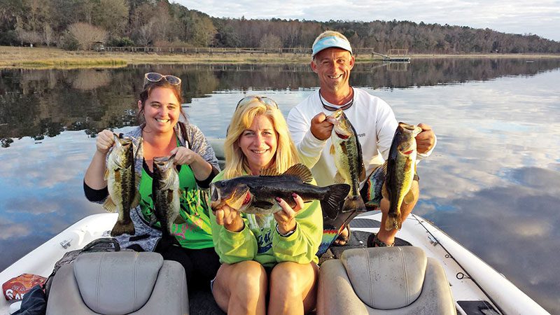 Lara Madeline, Julie Happersett & Eric Norberg holding some nice Lake Jackson bass from their day on the water with guide JR Mundinger.