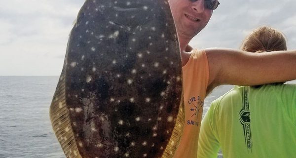 Patrick Horan with a nice 21 inch flounder fishing with Capt. Jason.