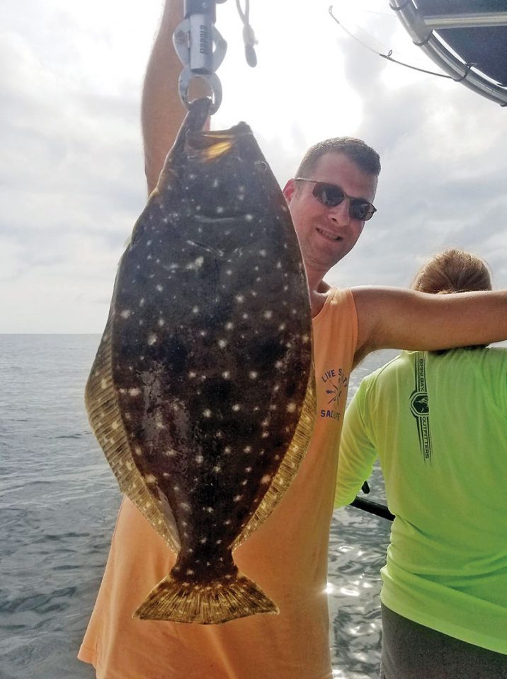 Patrick Horan with a nice 21 inch flounder fishing with Capt. Jason.