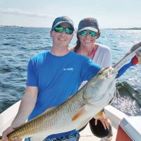 Siblings Patrick & Laura hauling in redfish.