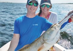 Siblings Patrick & Laura hauling in redfish.