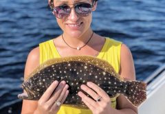 Tabitha hauling in flounder aboard Reel Screamer Charters with Capt Chris Nguyen