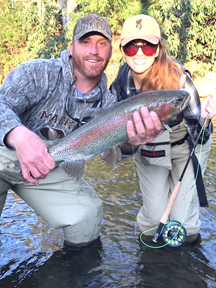 Amanda McLendon & Bryan Farley landing a trophy rainbow trout at Noontootla Creek Farms