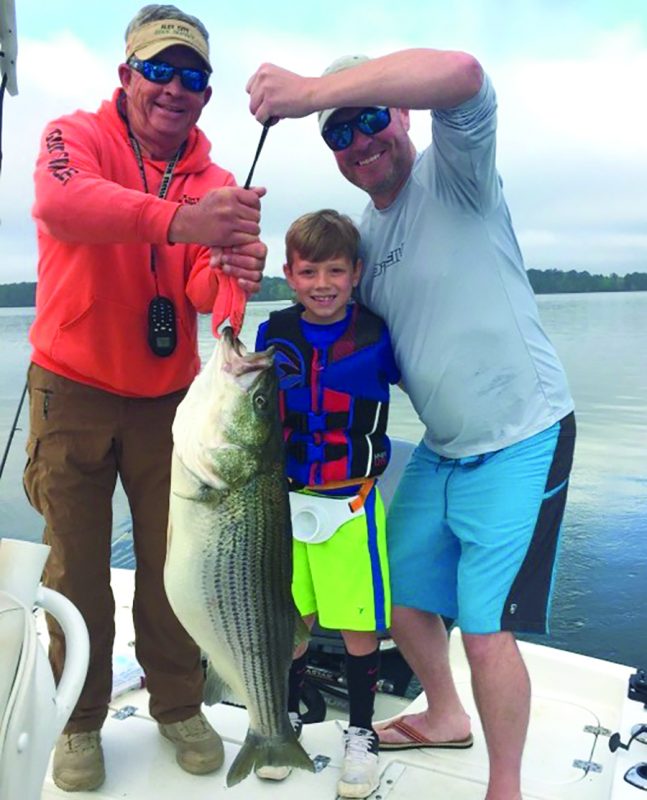 G C Lewis of Newnan, Ga brings his 8-year-old out for first time and young Lewis boats a 35 pounder 