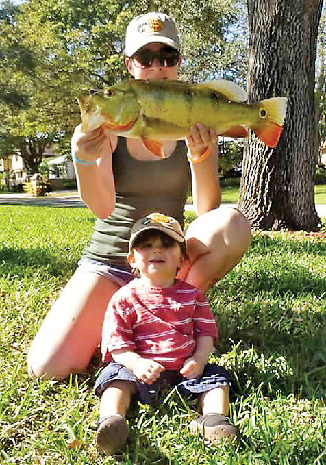 Tatiana teaching her son Nathan early with a nice peacock bass caught on a spinner bait.