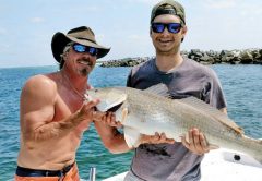 Bryan Ferns and Tim Morris of Panama City with a nice redfish aboard The Gun Show.