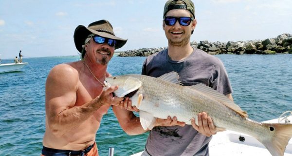 Bryan Ferns and Tim Morris of Panama City with a nice redfish aboard The Gun Show.