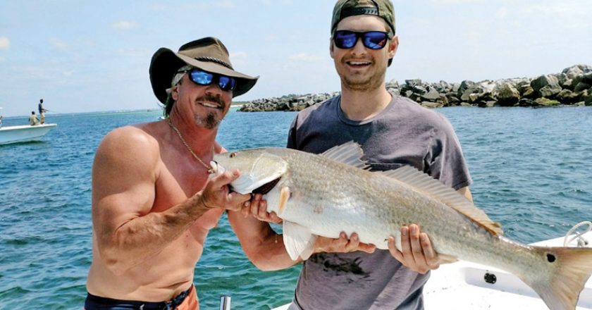 Bryan Ferns and Tim Morris of Panama City with a nice redfish aboard The Gun Show.