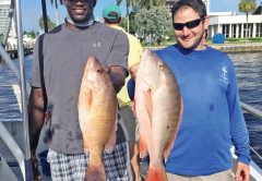 Evan and Mike with a couple nice snappers caught deep sea fishing aboard Catch My Drift.